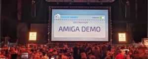 Large audience, bigscreen reading "Amiga Demo" at Revision 2018 demo party